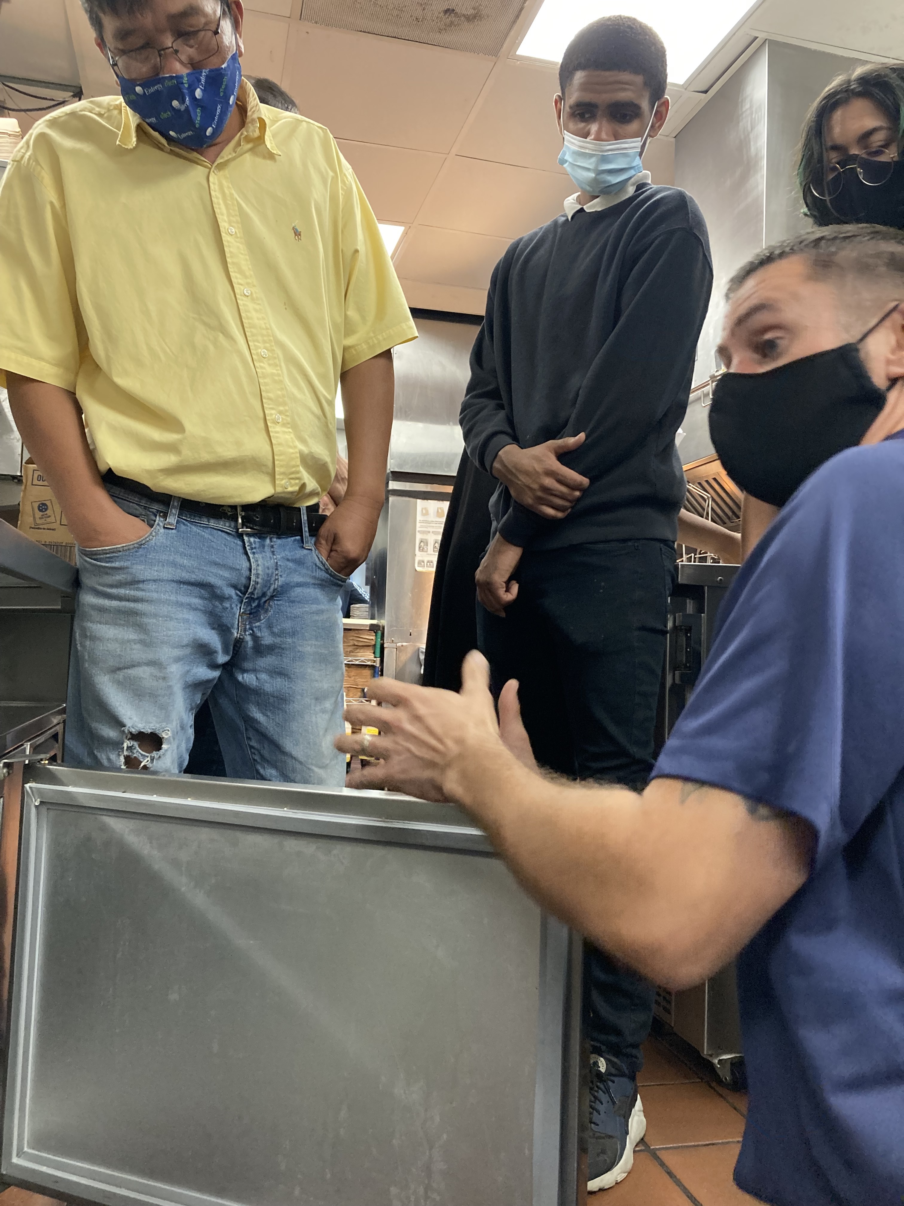 Nick Nguyen, Cyrill Banks and Gloria Figueroa visit local McDonalds to learn how maintaining gaskets help businesses with refrigeration keep energy use and cost low.